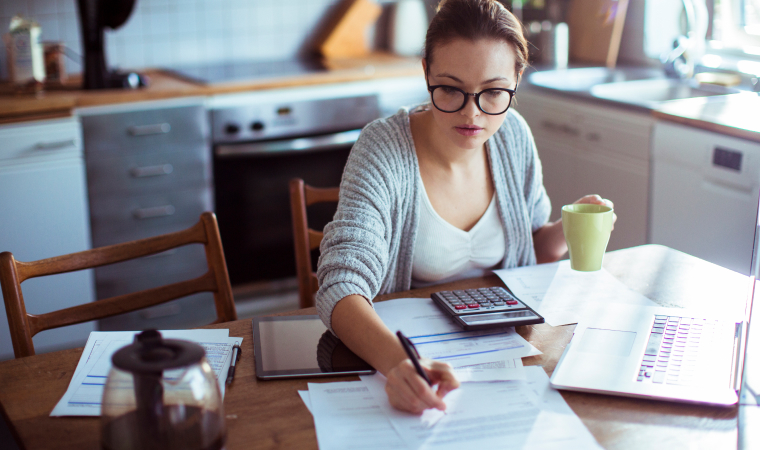 Canadian family reviewing Credit Union benefits and financial documents at kitchen table