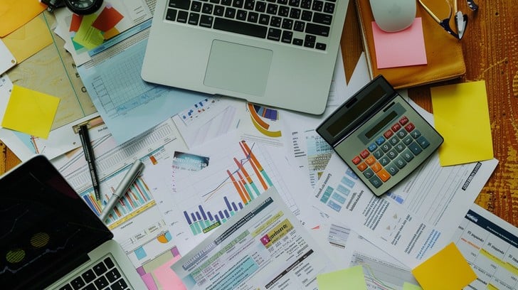 Financial planning workspace with charts and documents